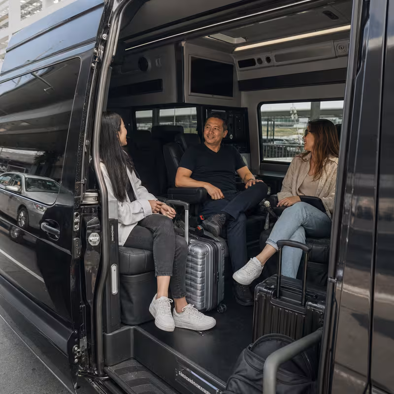 Passengers loading luggage while boarding an Hayward group shuttle