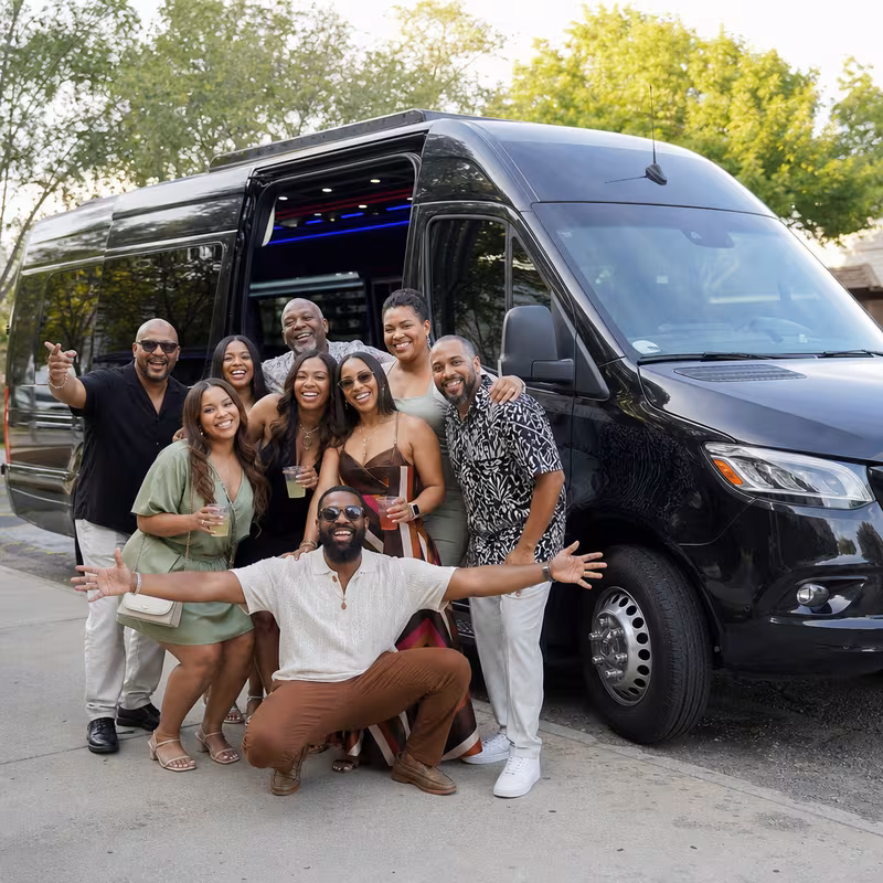 Group boarding a white charter bus for Birthday Transportation transportation in Hayward