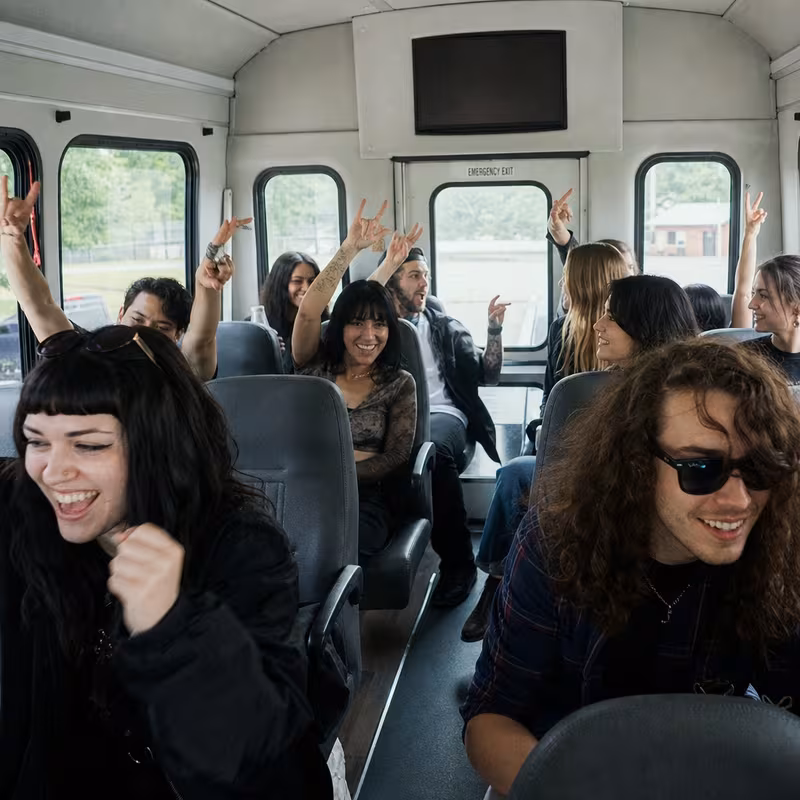 Party bus interior with wraparound leather seating and LED lighting in Hayward
