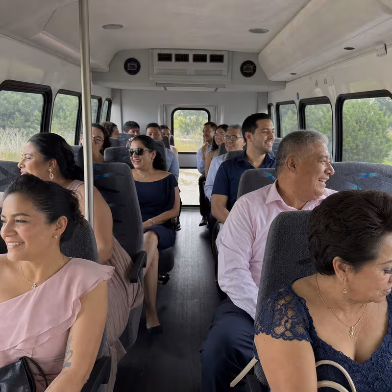 Group boarding a white charter bus for Private Event Transportation transportation in Hayward