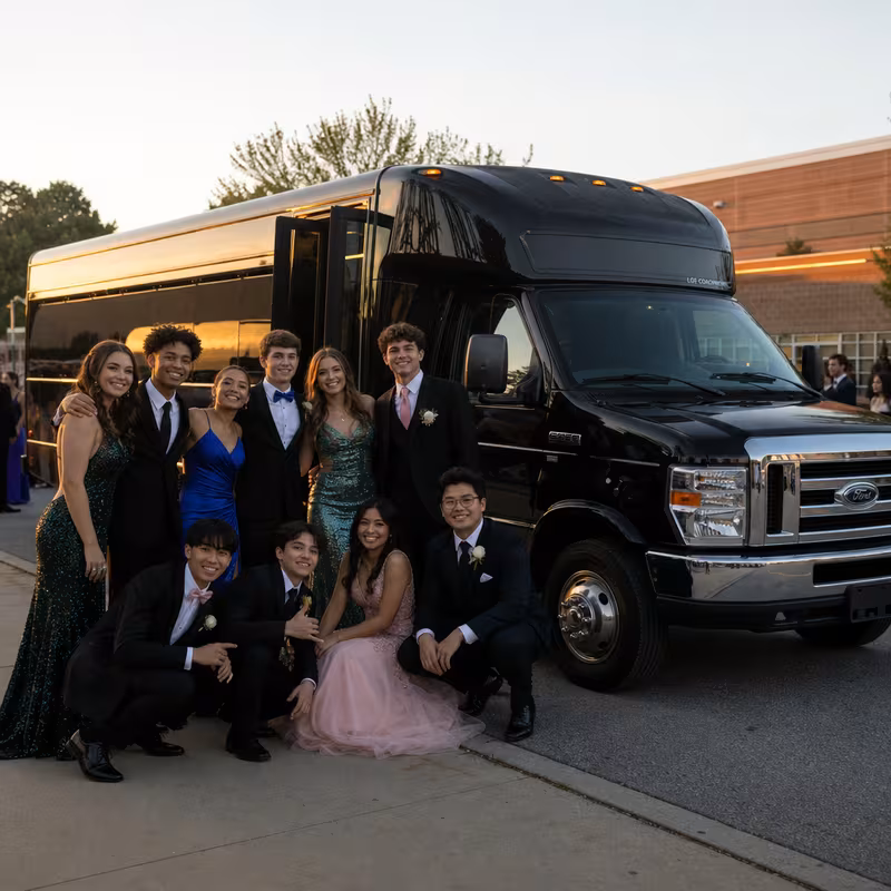Group boarding a white charter bus for Prom & Homecoming Transportation transportation in Hayward