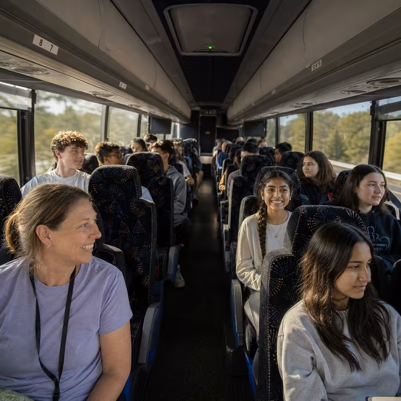 Group boarding a white charter bus for School Transportation transportation in Hayward