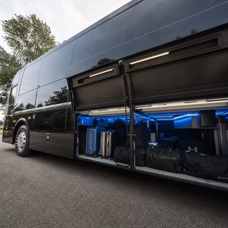 Party bus interior with wraparound leather seating and LED lighting in Hayward