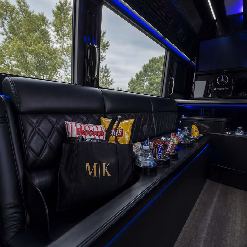 Party bus interior with wraparound leather seating and LED lighting in Hayward